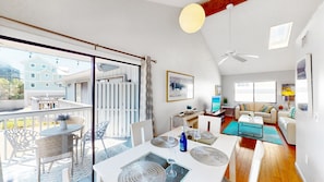 A spacious living area with a dining table, sofa, and a balcony with outdoor seating. - Beach Rd, 300ft to Beach Access & 500ft to Siesta Key Village, 2bdr (Siesta Key)