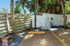 A small white building with a sign indicating reserved parking. - Beach Rd, 300ft to Beach Access & 500ft to Siesta Key Village, 1bdr (Siesta Key)