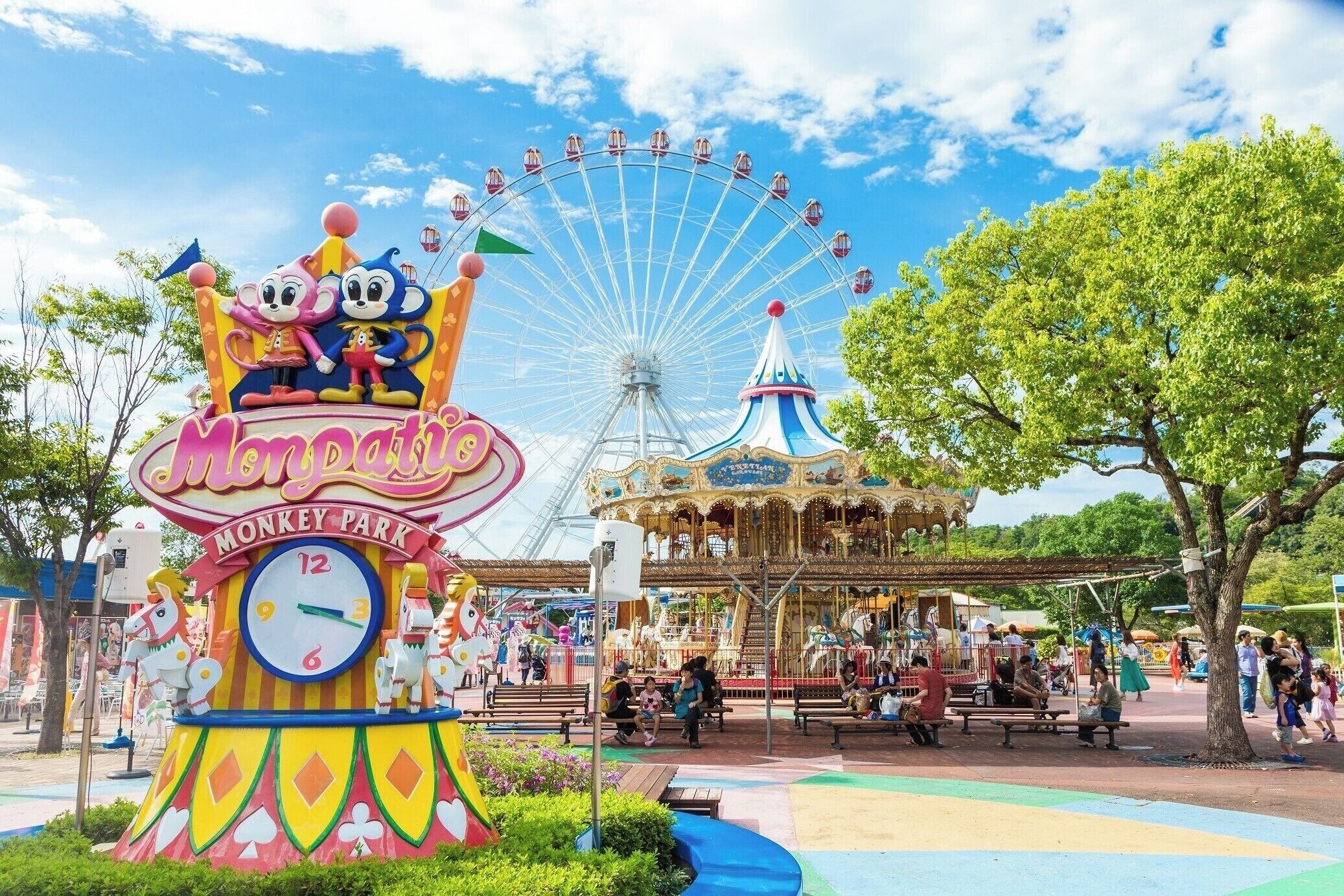 A carousel and a Ferris wheel at a theme park.