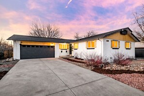 A single-story house with a garage, a front porch, and a driveway. - Château des Fleur-Min to Wash Park & DT Denver (Denver)