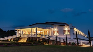 A large, modern house with a balcony and a staircase leading to the entrance. - Windermere Hotel (Shillong)