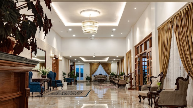 A spacious lobby with a polished marble floor, elegant furniture, and a large chandelier. - Windermere Hotel (Shillong)