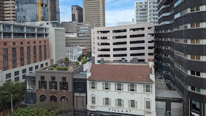 A cityscape with a mix of modern and historic buildings, including a prominent 'LUNO' sign and a 'VILLA 47' building. - Trendy Studio at the Barracks on Bree (Cape Town)