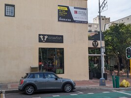 A building with a sign for 'Cowfish' and another for 'Louw & Coetzee Properties'.