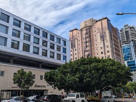 A modern building with a flat facade and large windows.