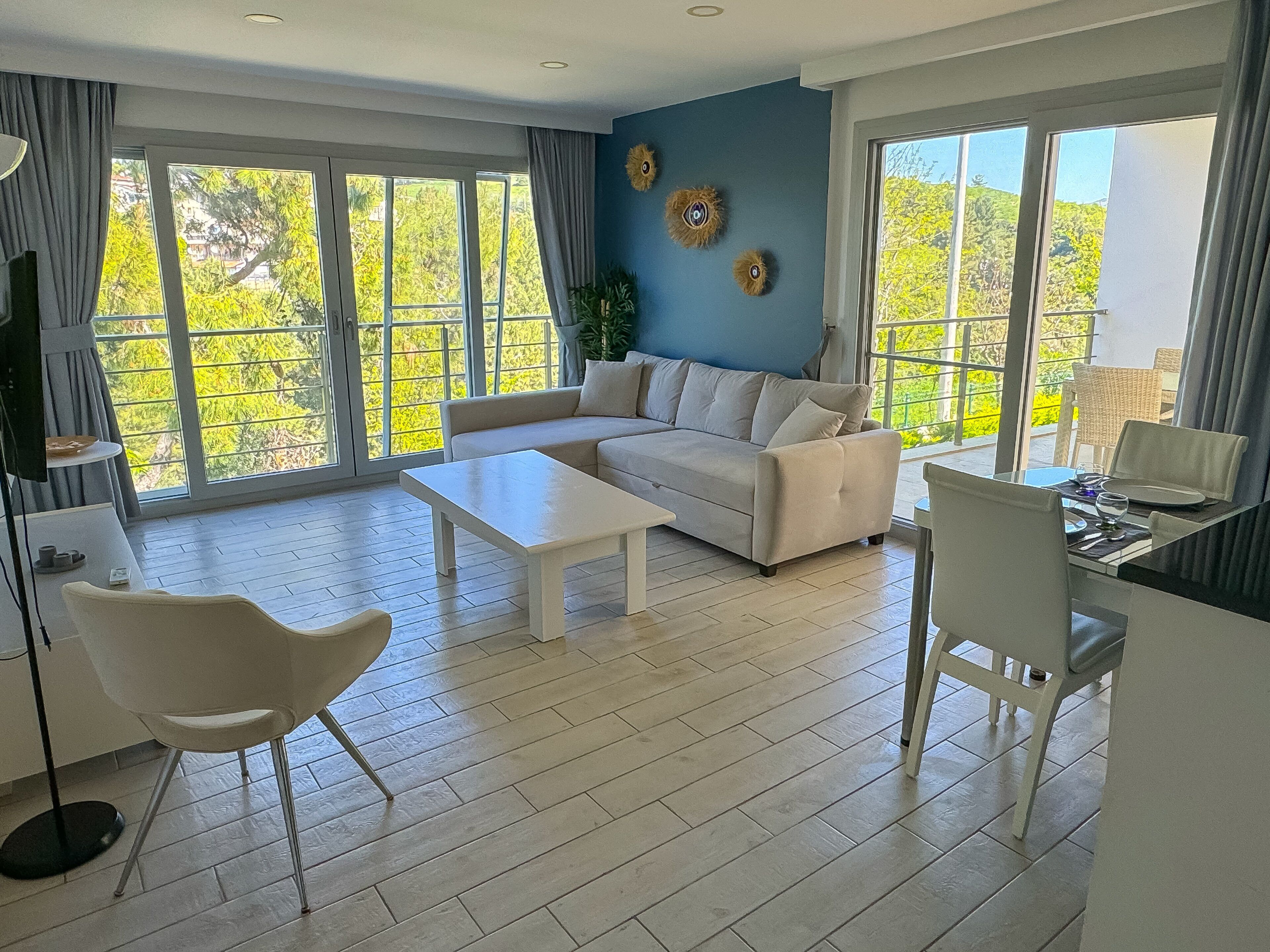 A modern living room with a sofa, coffee table, and dining area.