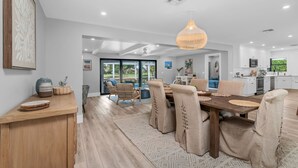 A modern kitchen with white cabinets, a microwave, and a large window. - Luxury Golf-View Oasis with Heated Pool & Quiet Marco Island Location (Marco Island)