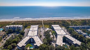 An aerial view of a coastal hotel with multiple buildings, a beach, and a clear view of the ocean. - Ocean View, Top Floor Condo in Hilton Head (Hilton Head Island)