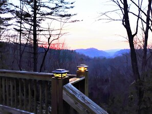 A wooden deck with two lantern-style lights. - Spectacular mountain views on the back deck! Waterfalls, hike, bike kayak nearby (Rosman)