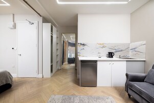 Luxury Studio | Living area | 45-inch Smart TV with digital channels, heated floors