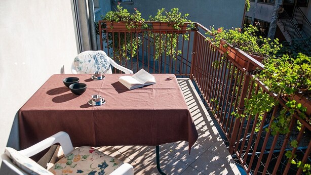 A small outdoor table with a brown tablecloth, a chair, and a book. - 2 bedrooms apartment Anita with BBQ (Pula)