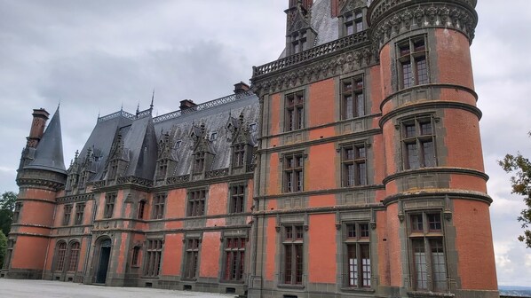 A historic building with a prominent tower, large windows, and intricate architectural details.
