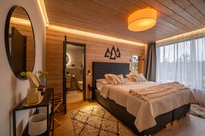 A modern bedroom with a bed, a mirror, a wooden ceiling, and a wall-mounted light fixture.