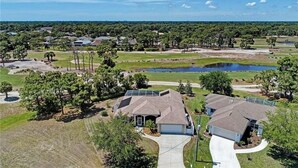 A residential area with houses, a pond, and a clear sky. - Turtle Bay, heated pool, 2 dogs ok, pool table (Rotonda West)