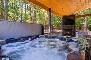 Uma banheira de hidromassagem com um deck de madeira e um letreiro da TreeLine Vacation Rentals.