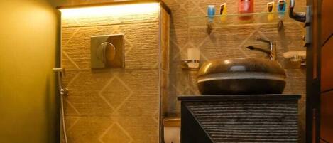 A compact bathroom with a toilet, sink, and mirror.