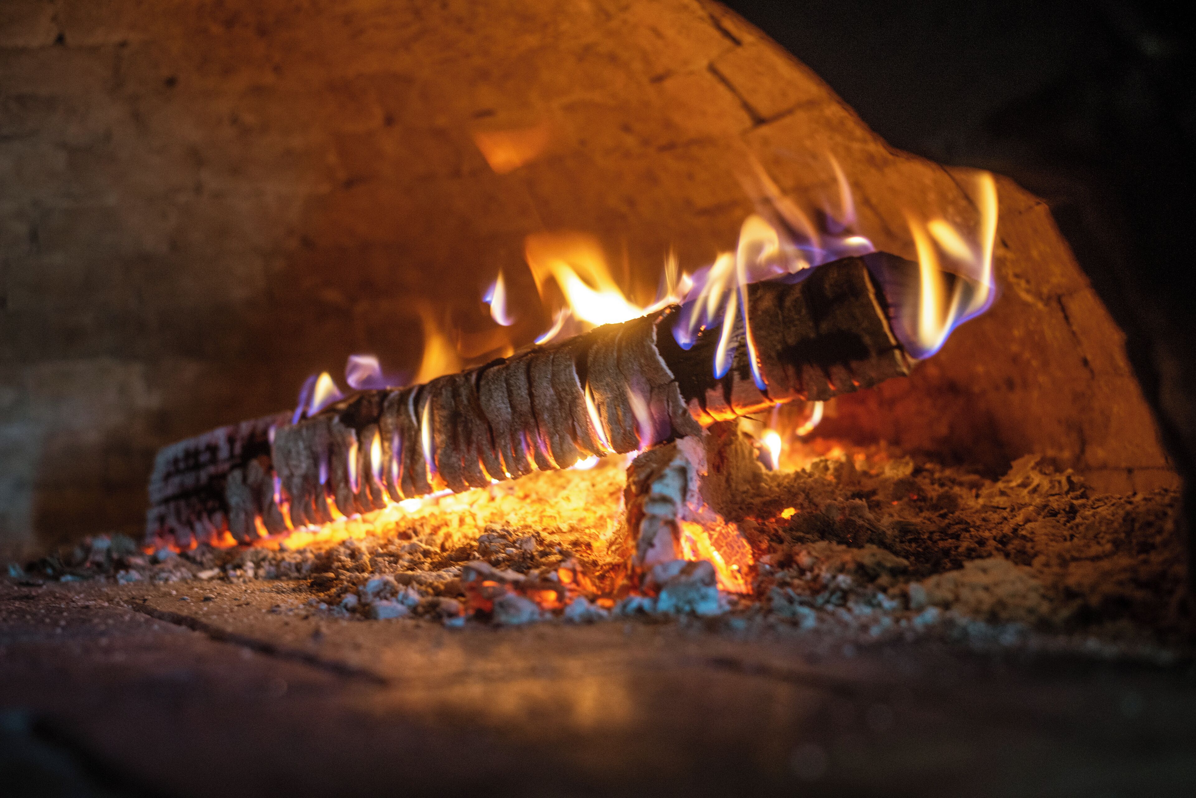 A close-up of a fire burning in a fireplace.