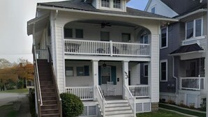 A two-story house with a front porch, a staircase, and a garage. - 1st-floor, 4-bedroom home, 1 block from beach in Ocean City, NJ (Ocean City)