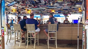 A bar area with wooden chairs and a counter.