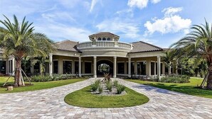 Un edificio grande de dos pisos, con un patio central, columnas y un paseo cubierto.
