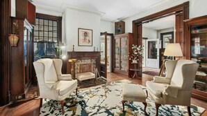 A traditional room with two armchairs, a fireplace, and a large mirror. - 5 bdrm Victorian, built in 1881-With 21 rooms, on a hill on 4 VERY private acres (New Windsor)