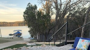 A patio area with blue cushioned seating and a small pool. - Lakeside House & Cabin Boat Ramp, Dock, & Fire Pit on Possum Kingdom Lake (Graham)