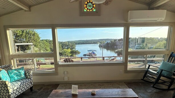 A room with a large window, a ceiling fan, a wooden ceiling, and a view of a lake. - Lakeside House & Cabin Boat Ramp, Dock, & Fire Pit on Possum Kingdom Lake (Graham)