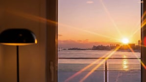A sunset view from a window with a lamp in the foreground. - Goseong Badasga per Osyeonbyu Pension (Goseong)