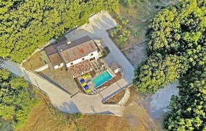 An aerial view of a property with a swimming pool, a fenced yard, and a building with a sloped roof. - Beautiful home in Orgnac-l'Aven (Orgnac-l'Aven)