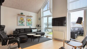 A modern living room with a sofa, chairs, a coffee table, and artwork on the wall. - "Borica" - 700m from the sea by Interhome (Løkken)