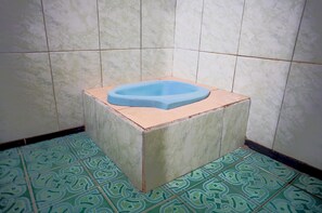 Economy Double Room | Bathroom | Shower, towels, soap - OYO Life 93712 Vanda Family (Blitar)