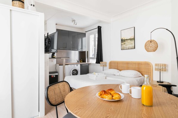 Relax in this stylish room with a large bed, dining table, and kitchenette.