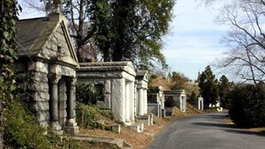 A cemetery with stone headstones and a paved road. - * Prime Location: 2-BR Oasis with Washer & Dryer * (Richmond)