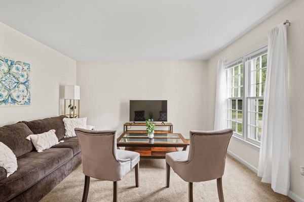 Relax in style in our plush living room, featuring ample seating and a sleek flat-screen Roku Smart TV.