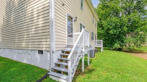 A two-story house with a front porch and a small deck. - * Prime Location: 2-BR Oasis with Washer & Dryer * (Richmond)