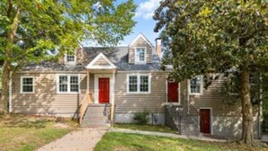 A two-story house with a front porch, a red door, and a small front yard. - $ Cozy 1BR 1BA Apartment: Near Fort Gregg-Adams $ (Hopewell)