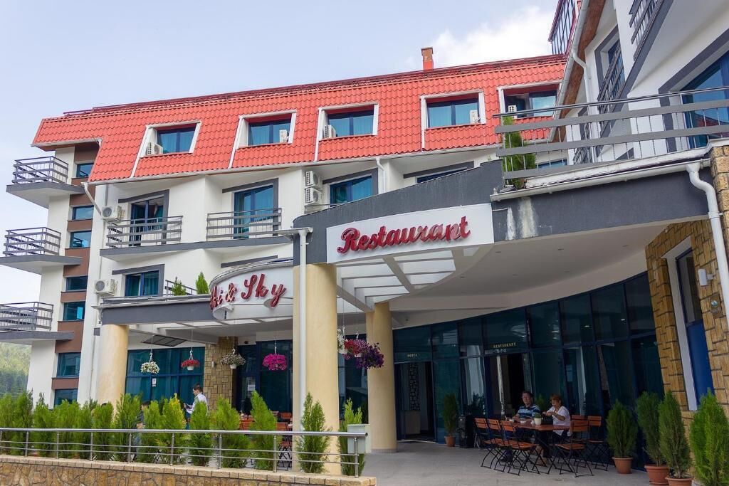 A restaurant with a red roof and a sign that reads "Restaurant."