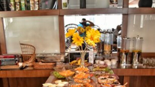 A buffet table with various food items including pastries, fruits, and meats. - Bladi Suite Oran (Oran)