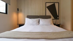 A hotel room with a large bed, two bedside tables, a wall-mounted artwork, and a window. - w* | Perfect 1BR w/ Great Deco in Barranco (Barranco)