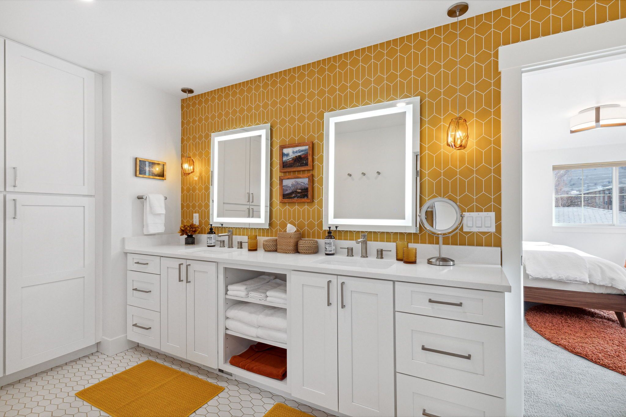 A modern bathroom with a large vanity, double sinks, and a mirror.