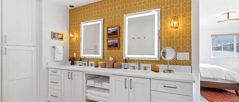 A modern bathroom with a large vanity, double sinks, and a mirror.