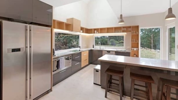 A modern kitchen with a large island, stainless steel appliances, and a view of the outdoors. - Serenity at Ridgeway Retreat Relax Hike Bike (Ridgeway)