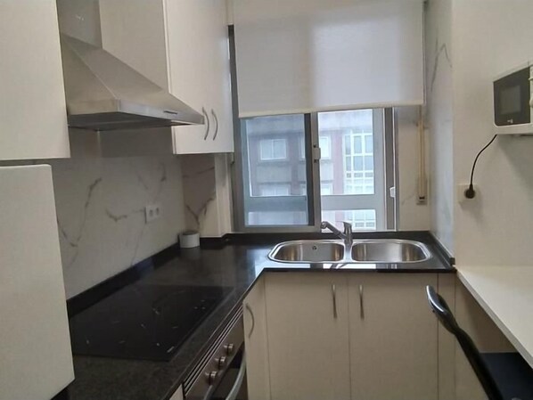 Fridge, microwave, coffee/tea maker, cookware/dishes/utensils
