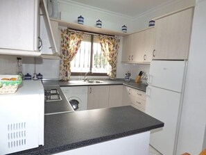 Fridge, microwave, coffee/tea maker, cookware/dishes/utensils