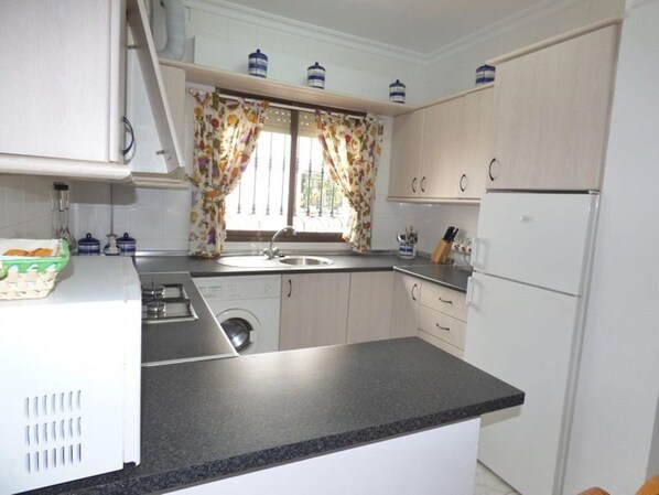 Fridge, microwave, coffee/tea maker, cookware/dishes/utensils