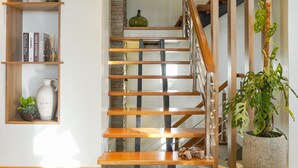 A staircase with wooden railings and a potted plant on the right. - Villa Ferrer (Mahatao)