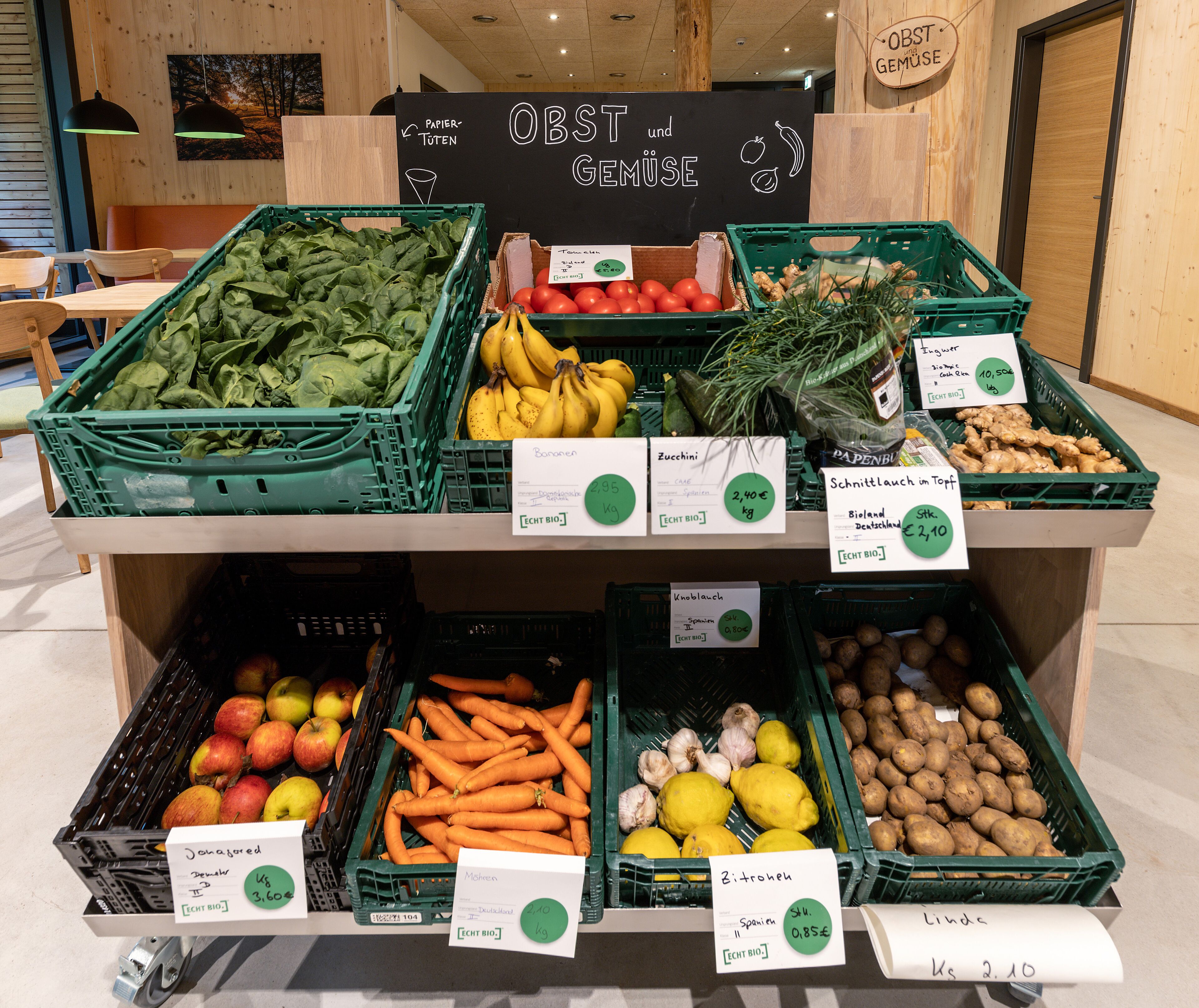A grocery display with various fresh produce and labeled prices.