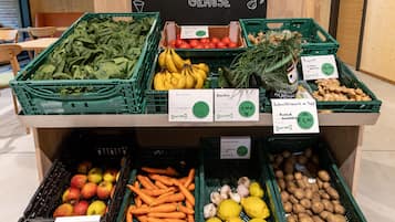 A grocery display with various fresh produce and labeled prices.