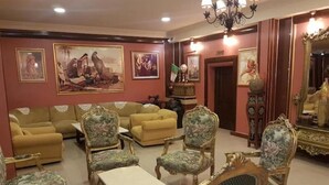 A room with ornate furniture, including a sofa set, armchairs, and a table. - Ambassadeurs Oran (Oran)