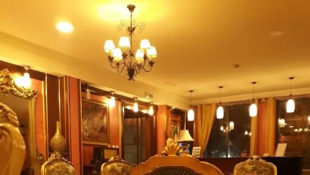 A formal dining room with ornate chairs, a chandelier, and a piano. - Ambassadeurs Oran (Oran)